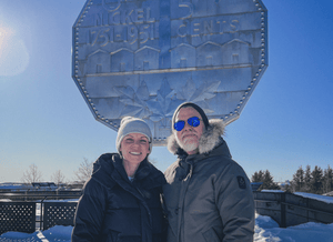 NorthTone founders standing in front of a the Big Nickel monument in Sudbury, Ontario on a clear day.